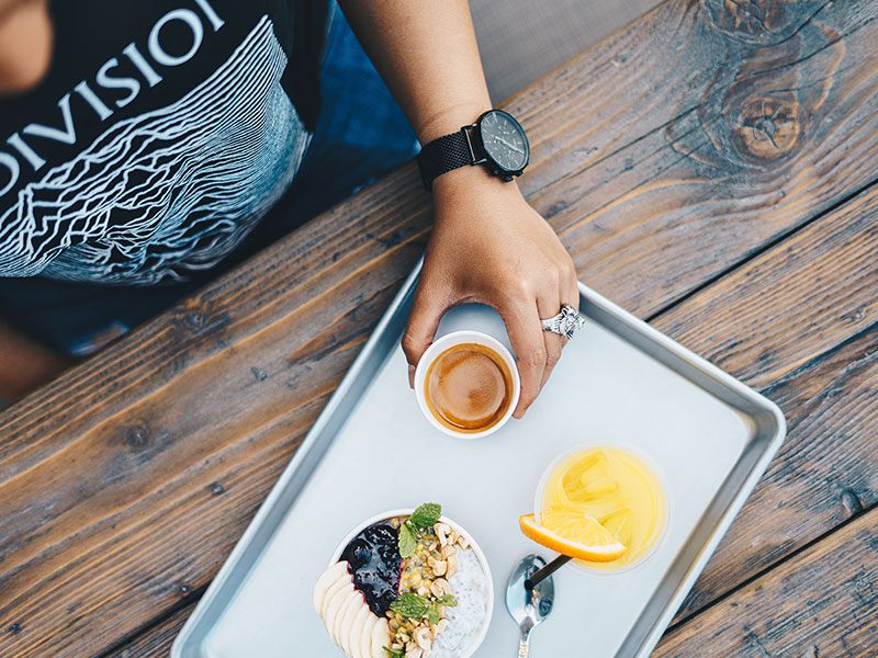Person Sitting with Breakfast Tray Person Sitting with Breakfast Tray