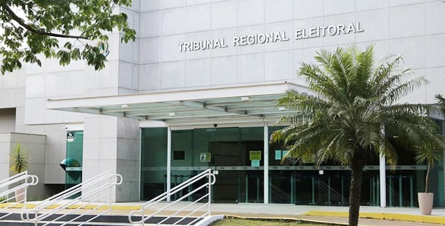Fachada do prédio do Tribunal Regional Eleitoral de Mato Grosso do Sul, em Campo Grande, com palmeira em frente à entrada